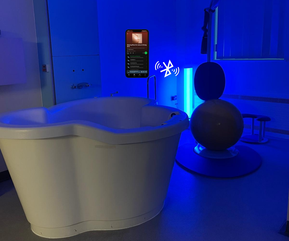 Birthing room with birth pool, birthing system and mood tube, with phone showing Bluetooth connectivity