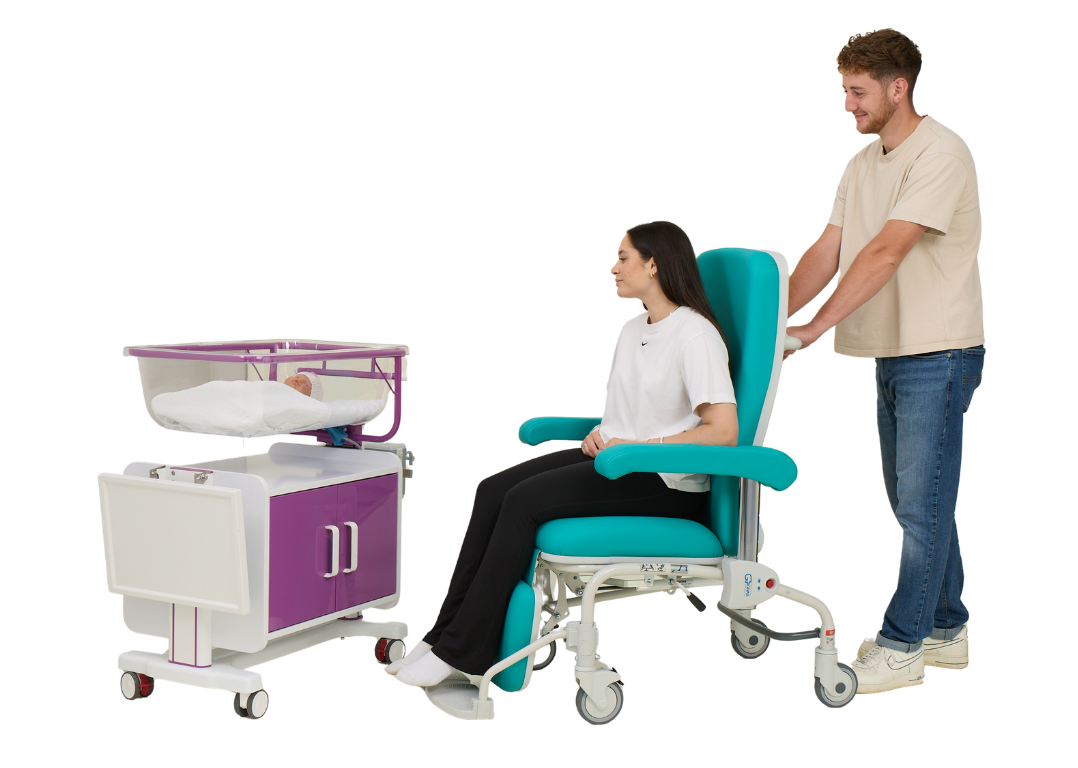 Dad pushing Mum in Kangaroo Chair to baby in storage cot