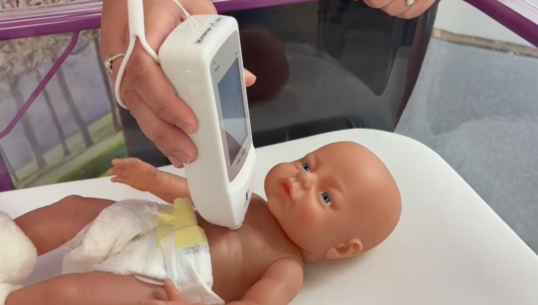 Jaundice meter probe being held against a baby doll's chest. Jaundice meter probe being held against a baby doll's chest.