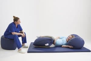 Midwife with woman using beanbag for labour