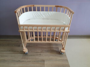 Baby crib with side rails in lowered position