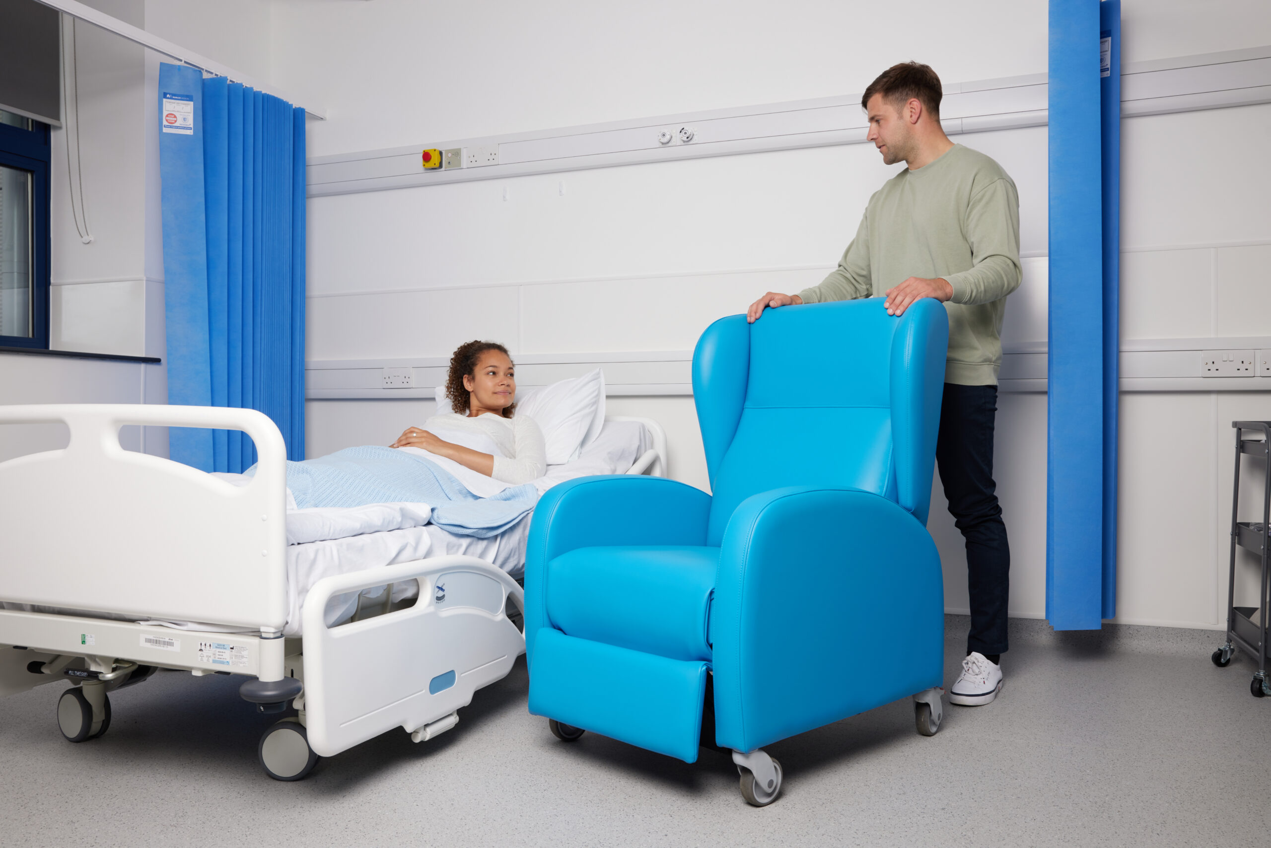 Man moving chair in hospital